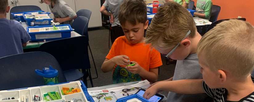 Young children learning coding with legos