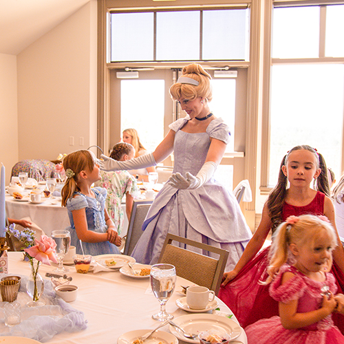 young girls around table meeting princess 