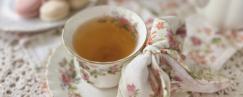 white floral teacup with tea 