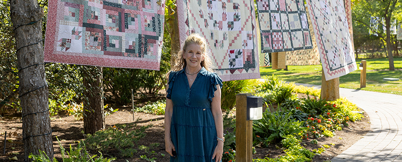 melissa gilbert in front of quilts in garden