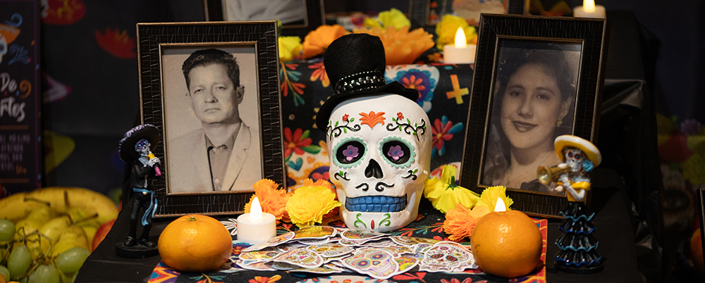 An ofrenda - a table with many photo frames of ancestors, artwork, displayed food and more. 