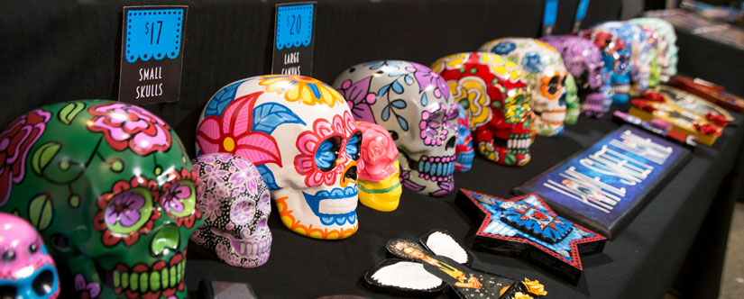 a row of brightly colored decorative skulls called calaveras