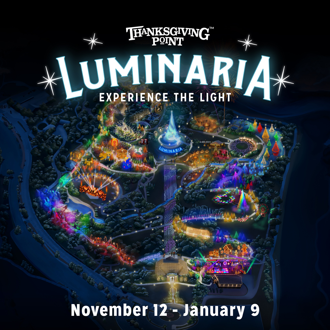 Long lines of lit luminaries with a colorful pattern leading to a pole strung with lights to look like a tree