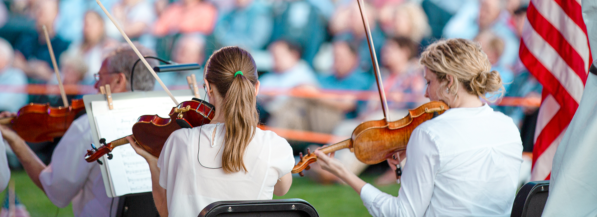 From the back of the crowd outdoors looking to the symphony
