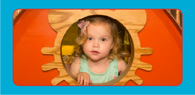 image of young girl looking through toy window