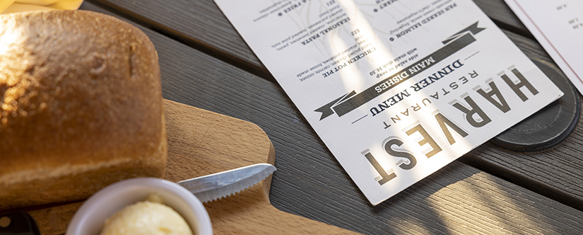 fresh bread on table with harvest restaurant menu