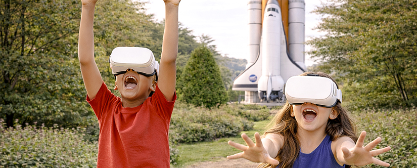 kids in front of space shuttle statue