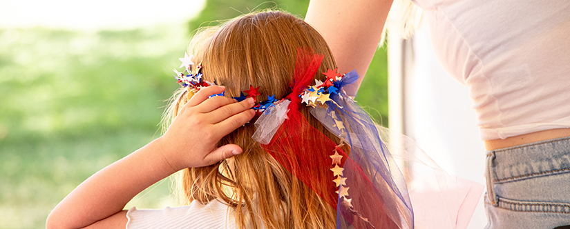 girl putting on sparkle crown