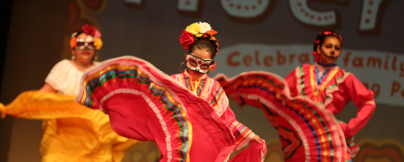 women dancing in traditional mexican dresses at thanksgiving point day of the dead